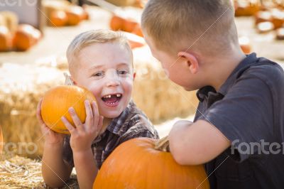 Two Boys at the Pumpkin Patch Talking and Having Fun