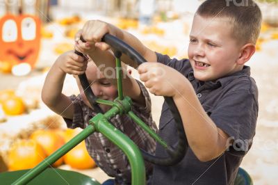 Adorable Young Boys Playing on an Old Tractor Outside Adorable Young Boys Playing on an Old Tractor Outside