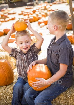 Two Boys at the Pumpkin Patch Talking and Having Fun