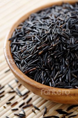 Wooden bowl full of wild rice