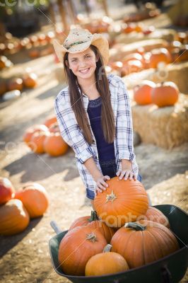 Preteen Girl Playing with a Wheelbarrow at the Pumpkin Patch