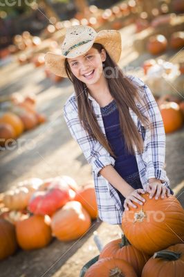 Preteen Girl Playing with a Wheelbarrow at the Pumpkin Patch