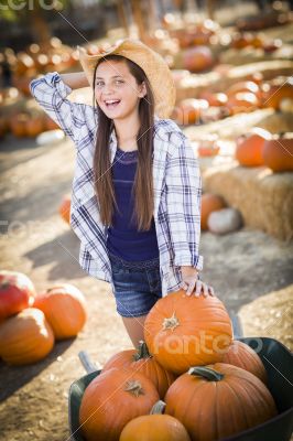 Preteen Girl Playing with a Wheelbarrow at the Pumpkin Patch