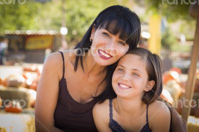 Attractive Mother and Daughter Portrait at the Pumpkin Patch