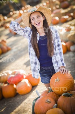 Preteen Girl Playing with a Wheelbarrow at the Pumpkin Patch