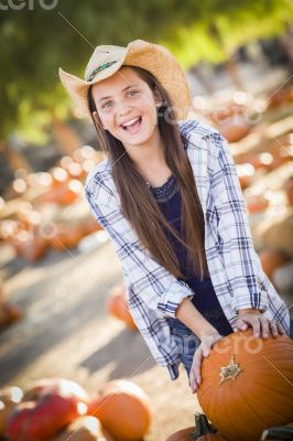 Preteen Girl Playing with a Wheelbarrow at the Pumpkin Patch