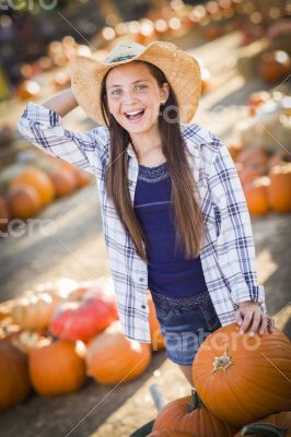 Preteen Girl Playing with a Wheelbarrow at the Pumpkin Patch