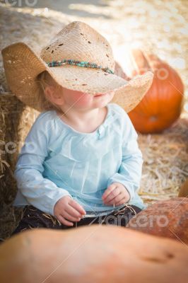 Adorable Baby Girl with Cowboy Hat at the Pumpkin Patch Adorable Baby Girl with Cowboy Hat at the Pumpkin Patch