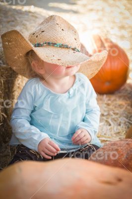 Adorable Baby Girl with Cowboy Hat at the Pumpkin Patch