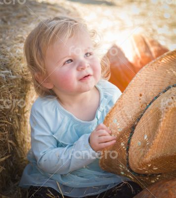Adorable Baby Girl with Cowboy Hat at the Pumpkin Patch