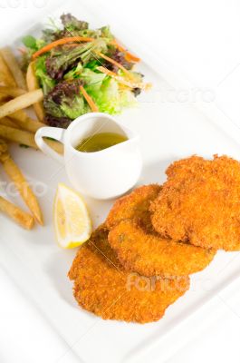 classic Milanese veal cutlets and vegetables