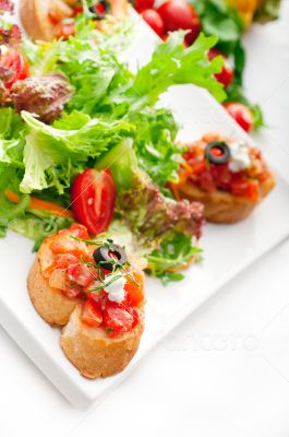 original Italian fresh bruschetta served with fresh salad and ve
