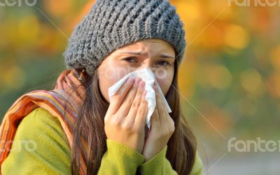 girl with allergy or cold using tissue