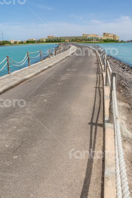 Narrow walkway along the sea