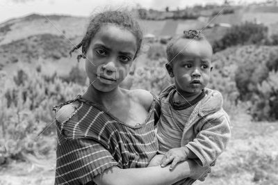 Young girl with her baby brother