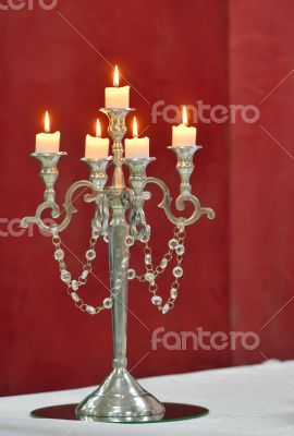 Silver classic candlestick isolated on red