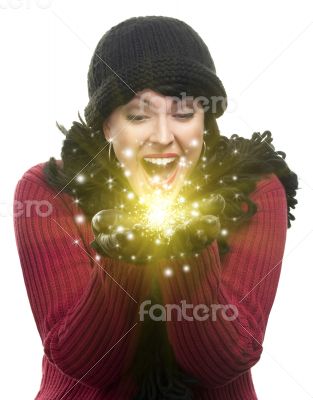 Excited Woman In Winter Clothes Holds Something Sparkling In Han