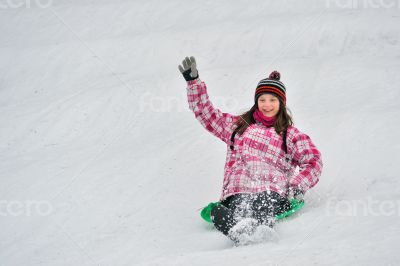 girl sliding in the snow