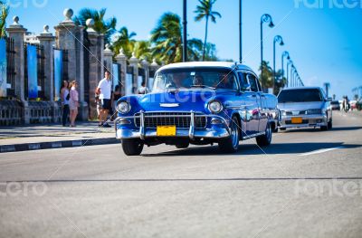 Caribbean Cuba classic car traveling on the promenade in Havana