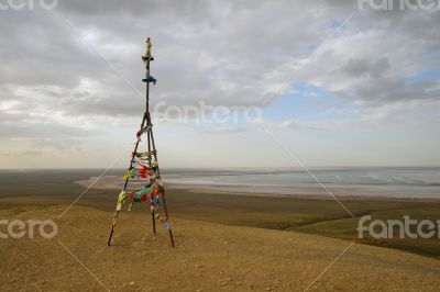 Triangulation mark with buddhist prayer flags