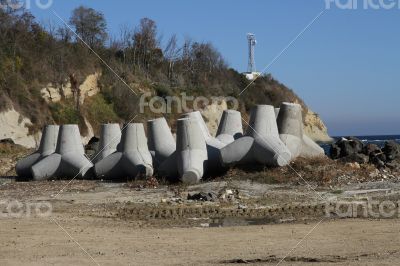 Breakwaters on the boat station. Large gray breakwaters installed at the seaport to reduce the waves.