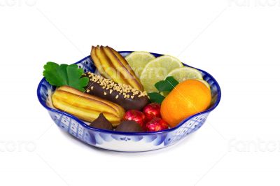 Cakes, sweets, fruit in a vase, painted in the style of the `Gzh