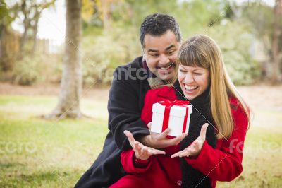 Mixed Race Couple Sharing Christmas or Valentines Day Gift Outsi