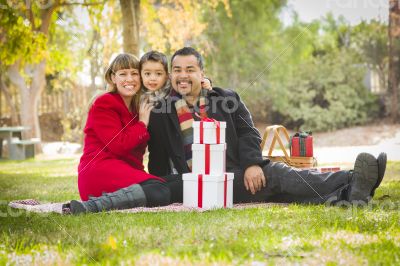 Mixed Race Family Enjoying Christmas Gifts in the Park Together