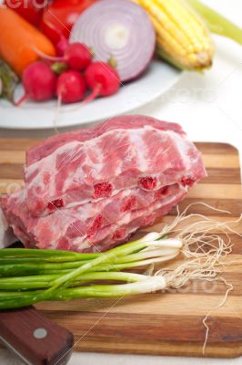 chopping fresh pork ribs and vegetables