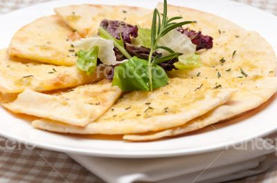 garlic pita bread pizza with salad on top