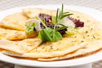 garlic pita bread pizza with salad on top