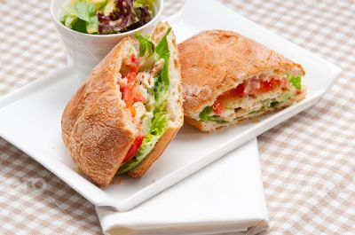 ciabatta panini sandwich with chicken and tomato