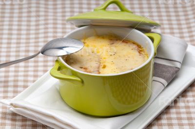 onion soup with melted cheese and bread on top