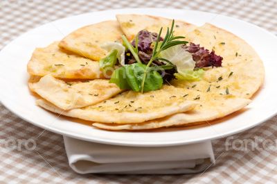 garlic pita bread pizza with salad on top