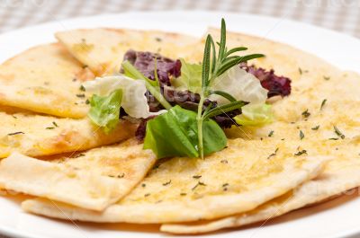 garlic pita bread pizza with salad on top