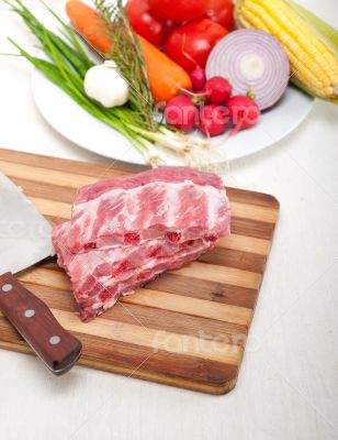 chopping fresh pork ribs and vegetables