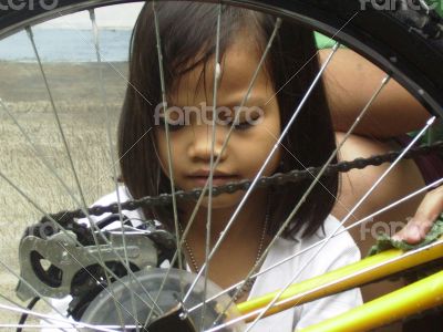 a little girl was washing the bike