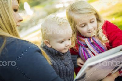 Mother Reading a Book to Her Two Adorable Blonde Children
