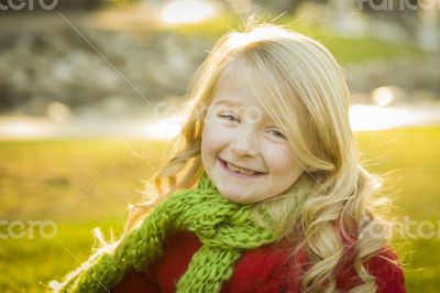 Little Girl Wearing Winter Coat and Scarf at the Park