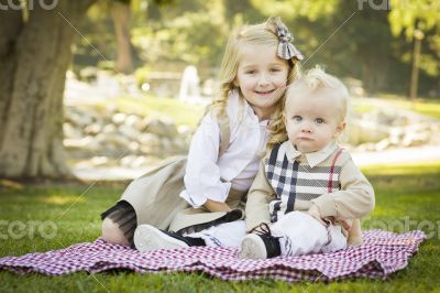 Sweet Little Girl with Her Baby Brother at the Park