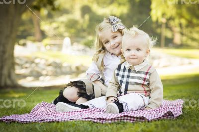 Sweet Little Girl with Her Baby Brother at the Park