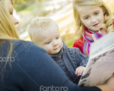 Mother Reading a Book to Her Two Adorable Blonde Children