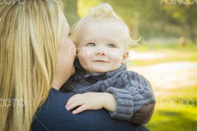 Mother Embracing Her Adorable Blonde Baby Boy