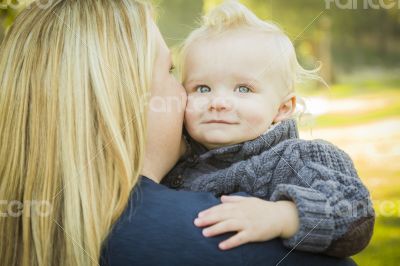 Mother Embracing Her Adorable Blonde Baby Boy