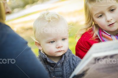 Mother Reading a Book to Her Two Adorable Blonde Children