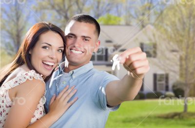 Military Couple with House Keys In Front of New Home