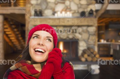 Mixed Race Girl Enjoying Warm Fireplace In Rustic Cabin