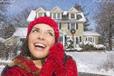 Smiling Mixed Race Woman in Winter Clothing Outside in Snow