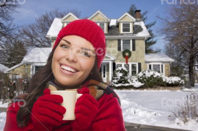 Smiling Woman in Winter Clothing Holding Mug Outside in Snow