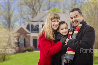 Happy Mixed Race Family in Front of House